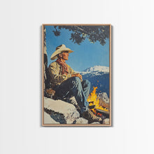 Load image into Gallery viewer, Cowboy Resting by the Fire Canvas Print, Winter Mountain Scene, Seasonal Wall Art, Rustic Western Decor, Holiday Gift, Framed Canvas Print