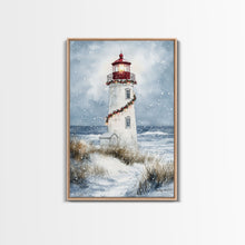 Carregar imagem no visualizador da galeria, Snowy lighthouse wrapped with festive garland, Framed Canvas Print, beach Christmas decor, holiday wall art perfect for coastal homes