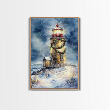 Load image into Gallery viewer, Snowy lighthouse under moonlit sky with wreath, Framed Canvas Print, beach Christmas decor for winter wonderland, holiday wall art