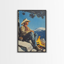 Load image into Gallery viewer, Cowboy Resting by the Fire Canvas Print, Winter Mountain Scene, Seasonal Wall Art, Rustic Western Decor, Holiday Gift, Framed Canvas Print