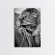 Load image into Gallery viewer, Close-up of cowboy hands holding reins, detailed Western art, black and white photography, Framed Canvas Print, rustic home decor, wall art