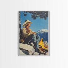 Load image into Gallery viewer, Cowboy Resting by the Fire Canvas Print, Winter Mountain Scene, Seasonal Wall Art, Rustic Western Decor, Holiday Gift, Framed Canvas Print
