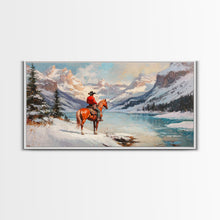 Load image into Gallery viewer, Cowboy on horseback near hay bale outside rustic barn, snow-covered landscape, Framed Canvas Print, winter wall art, rustic farmhouse decor