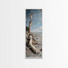 Carregar imagem no visualizador da galeria, Framed Canvas Print Skinny Art of a Weathered Driftwood Tree Trunk on a Sandy Shore with a Calm Ocean Backdrop, Ideal Tall Art for Coastal Decor