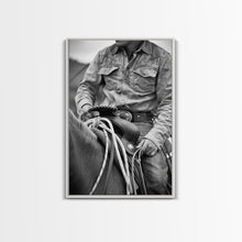 Load image into Gallery viewer, Close-up of cowboy hands holding reins, detailed Western art, black and white photography, Framed Canvas Print, rustic home decor, wall art