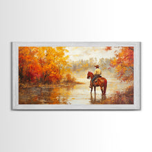 Load image into Gallery viewer, Cowboy sitting by campfire near a lake in the woods with autumn leaves, Framed Canvas Print, moody fall wall art, rustic western home decor