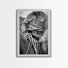 Load image into Gallery viewer, Close-up of cowboy hands holding reins, detailed Western art, black and white photography, Framed Canvas Print, rustic home decor, wall art