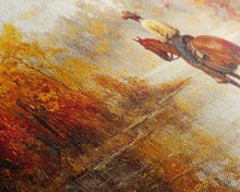 Load image into Gallery viewer, Cowboy sitting by campfire near a lake in the woods with autumn leaves, Framed Canvas Print, moody fall wall art, rustic western home decor