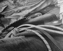 Load image into Gallery viewer, Close-up of cowboy hands holding reins, detailed Western art, black and white photography, Framed Canvas Print, rustic home decor, wall art