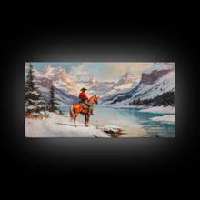 Load image into Gallery viewer, Cowboy on horseback near hay bale outside rustic barn, snow-covered landscape, Framed Canvas Print, winter wall art, rustic farmhouse decor