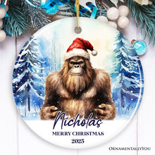 Load image into Gallery viewer, Bigfoot with Santa Hat Personalized Ornament, Winter Forest Christmas Gift With Custom Name and Date
