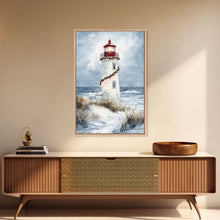 Carregar imagem no visualizador da galeria, Snowy lighthouse wrapped with festive garland, Framed Canvas Print, beach Christmas decor, holiday wall art perfect for coastal homes