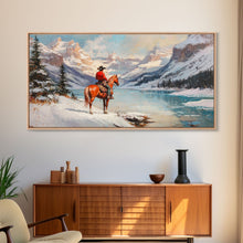 Load image into Gallery viewer, Cowboy on horseback near hay bale outside rustic barn, snow-covered landscape, Framed Canvas Print, winter wall art, rustic farmhouse decor
