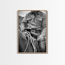Load image into Gallery viewer, Close-up of cowboy hands holding reins, detailed Western art, black and white photography, Framed Canvas Print, rustic home decor, wall art
