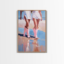 Load image into Gallery viewer, Cowgirls walking on the beach wearing pink cowboy boots, artistic reflection Framed Canvas Print - beach fashion, summer decor, vibrant art
