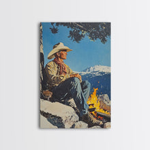 Load image into Gallery viewer, Cowboy Resting by the Fire Canvas Print, Winter Mountain Scene, Seasonal Wall Art, Rustic Western Decor, Holiday Gift, Framed Canvas Print
