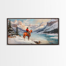 Load image into Gallery viewer, Cowboy on horseback near hay bale outside rustic barn, snow-covered landscape, Framed Canvas Print, winter wall art, rustic farmhouse decor

