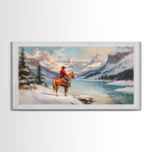 Load image into Gallery viewer, Cowboy on horseback near hay bale outside rustic barn, snow-covered landscape, Framed Canvas Print, winter wall art, rustic farmhouse decor

