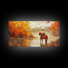 Load image into Gallery viewer, Cowboy sitting by campfire near a lake in the woods with autumn leaves, Framed Canvas Print, moody fall wall art, rustic western home decor
