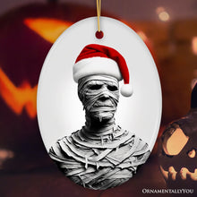 Load image into Gallery viewer, Ghoulish Mummy with Santa Hat Ornament, Sinister Holiday Keepsake for Halloween Lovers
