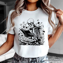 Load image into Gallery viewer, Gothic Reading Skeleton T-Shirt, Floral Halloween Tee for Spooky Bookworms
