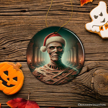 Carregar imagem no visualizador da galeria, Ancient Mummy with Santa Hat Ornament, Enigmatic Holiday Gift for Horror Enthusiasts
