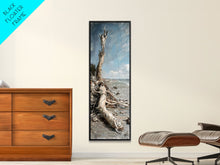 Carregar imagem no visualizador da galeria, Framed Canvas Print Skinny Art of a Weathered Driftwood Tree Trunk on a Sandy Shore with a Calm Ocean Backdrop, Ideal Tall Art for Coastal Decor
