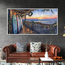 Carregar imagem no visualizador da galeria, Beachfront porch with surfboards and Christmas lights, Framed Canvas Print with wreaths festive lights, coastal holiday wall art and decor
