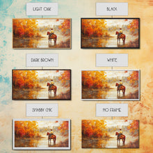 Load image into Gallery viewer, Cowboy sitting by campfire near a lake in the woods with autumn leaves, Framed Canvas Print, moody fall wall art, rustic western home decor
